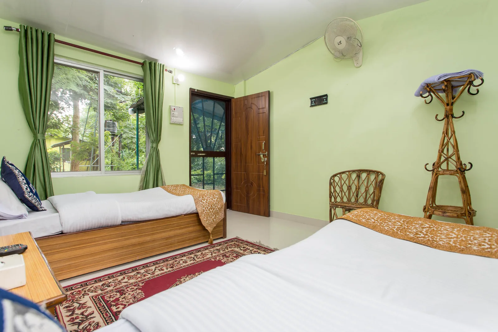 Twin room at Shuklaphanta Jungle Cottage with garden-facing window and jungle view
